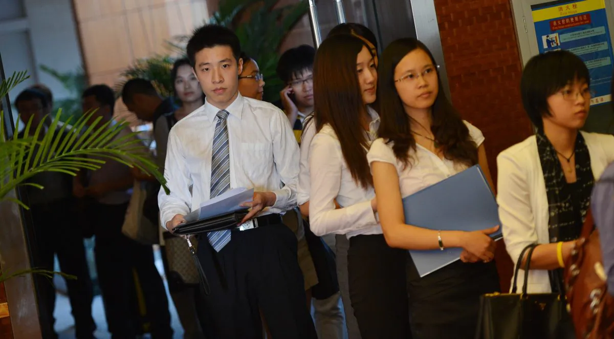 Unemployed Chinese graduates from British universities attend the LSE Beijing Career Fair as they search for jobs offered by foreign companies in Beijing, China, on Sept. 3, 2012. (MARK RALSTON/AFP/GettyImages)