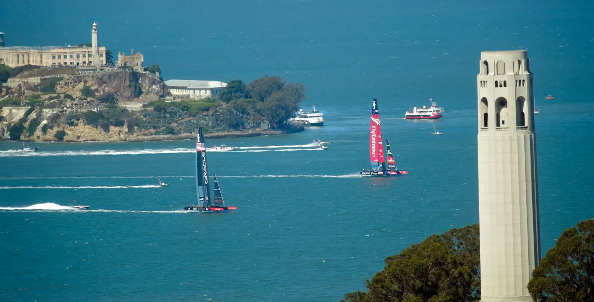 Coit Tower, Emirates Team New Zealand (R) and Oracle Team USA sail during the America's Cup race 11 in San Francisco on Sept. 18, 2013. (Noah Berger/Getty Images)