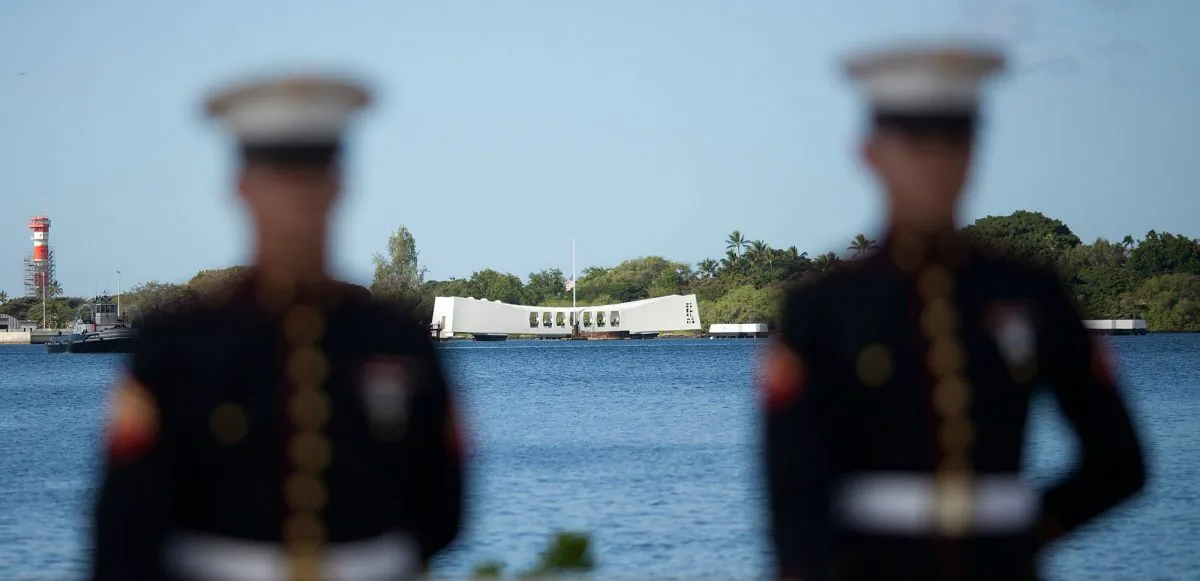 A U.S. Marine firing detail stands at attention with the Arizona Memorial in background during a memorial service on Dec. 7, 2011, for the 70th anniversary of the attack on the U.S. naval base at Pearl Harbor in 1941. (Kent Nishimura/Getty Images)