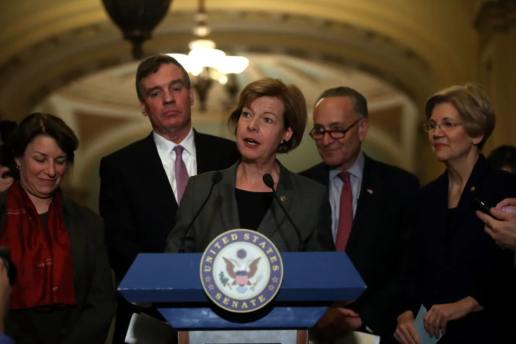 Sen. Tammy Baldwin (C) (D-Wis.) speaks with Sen. Amy Klobuchar (L) (D-Minn.) Sen. Mark Warner (2L) (D-Va.) Senate Minority Leader Charles Schumer (2R) (D-N.Y.) and Sen. Elizabeth Warren (R) (D-Mass.)by her side during a news conference on Capitol Hill in Washington, D.C. on March 14, 2017. (Justin Sullivan/Getty Images)