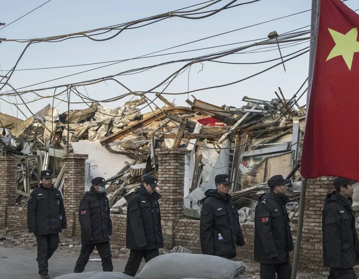 Chinese police walk in a line passed buildings demolished by authorities in an area that used to have migrant housing and factories in the Daxing District of Beijing, China on Dec. 6, 2017. (Kevin Frayer/Getty Images)