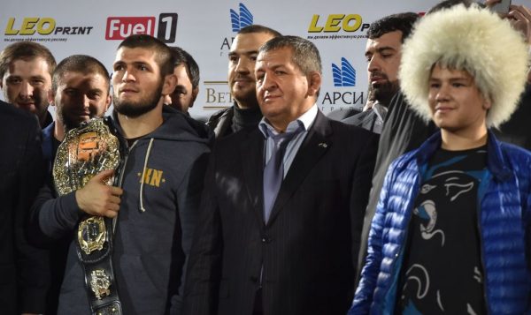 Khabib stands on stage with his father