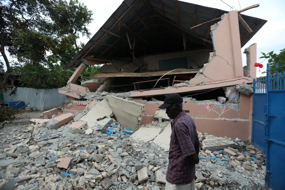 A man walks front of a school damaged in an earthquake, that hit northern Haiti in GROS MORNE, Haiti, Oct. 8, 2018. (Reuters/Ricardo Rojas)