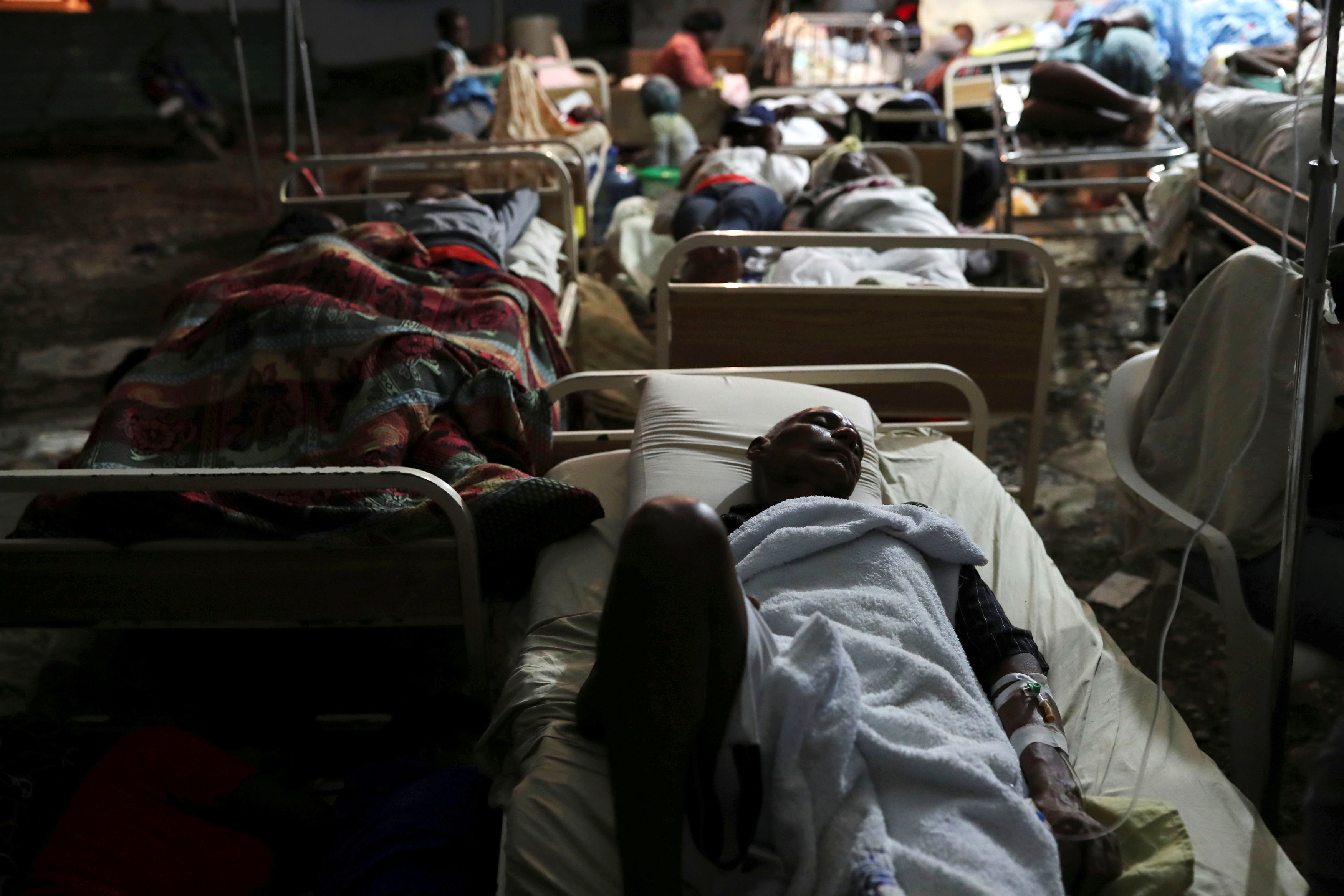 People injured in an earthquake that hit northern Haiti late on Saturday, sleep in a tent, in Port-de-Paix