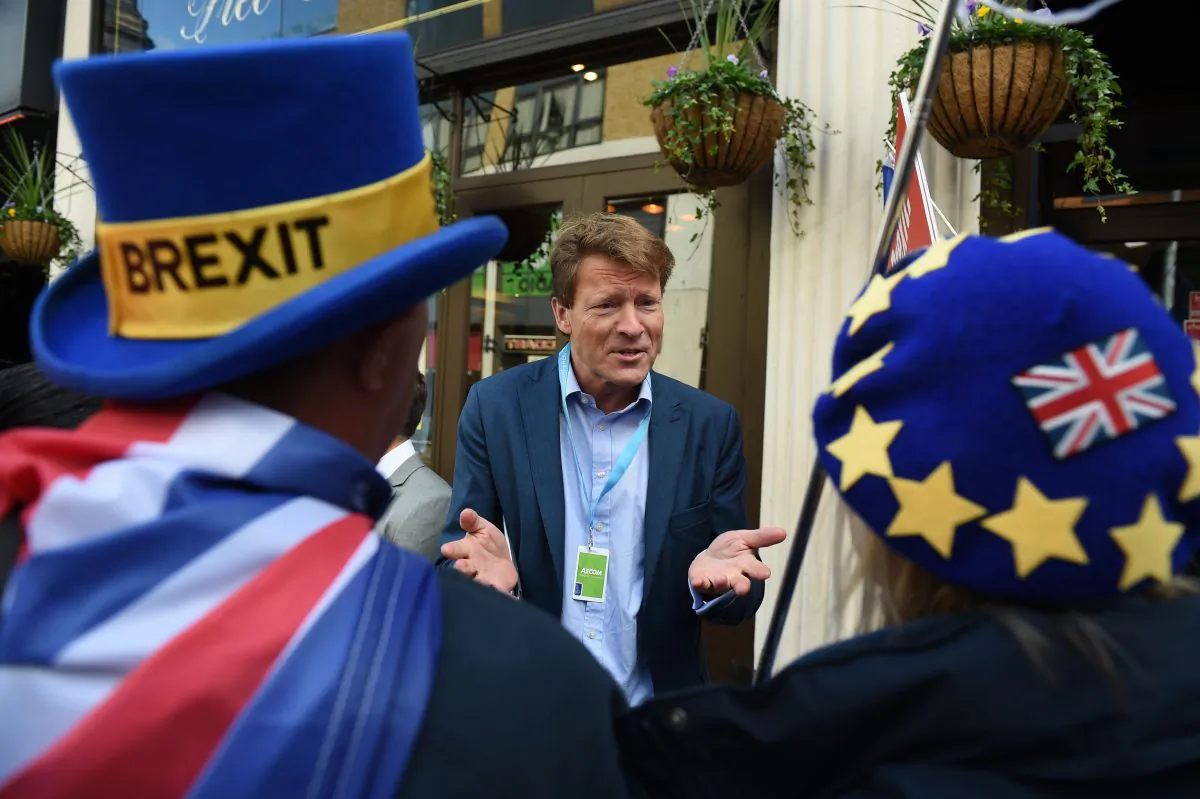 The 'Leave Means Leave' Brexit campaign co-chair Richard Tice (C) talks to anti-Brexit activists at a fringe event at the Conservative Party Conference in Birmingham, England, on Oct. 1, 2018. (Oli Scarff/ AFP/Getty Images) 