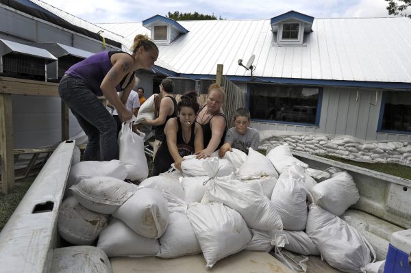 people lay sandbags to prepare for Hurricane Michael