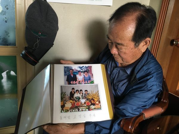 Koh Ho-jun shows photos of the family of one of his nieces in North Korea.