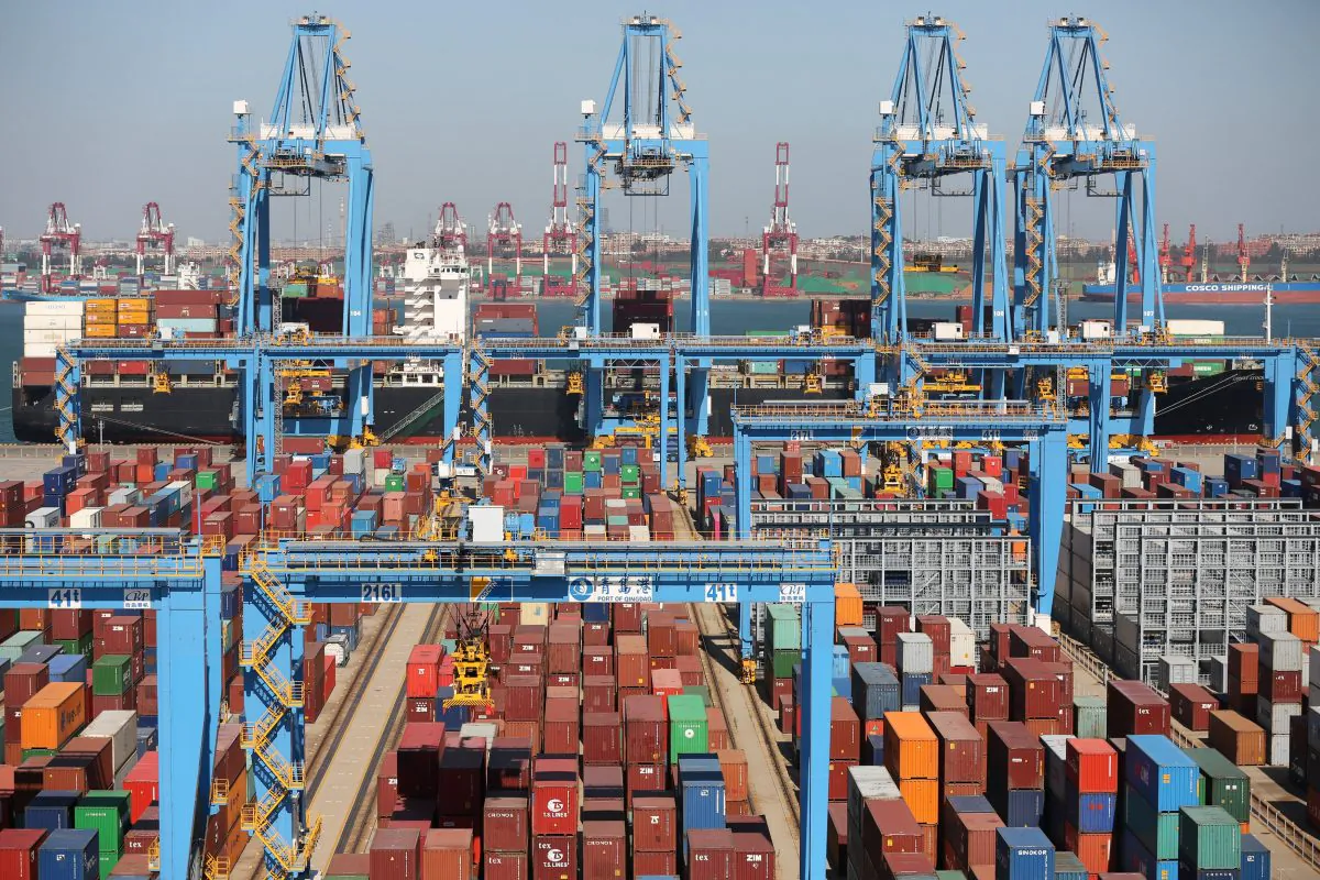 A cargo ship is seen behind containers at an automated container terminal in Qingdao port, Shandong Province, China on Oct. 1, 2018. (Reuters/Stringer)
