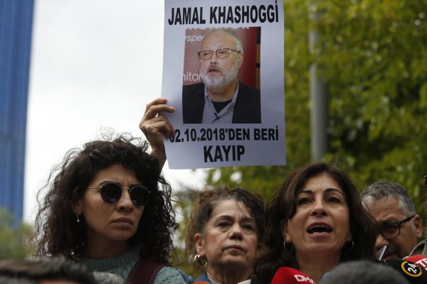 holding posters photos missing journalist Jamal