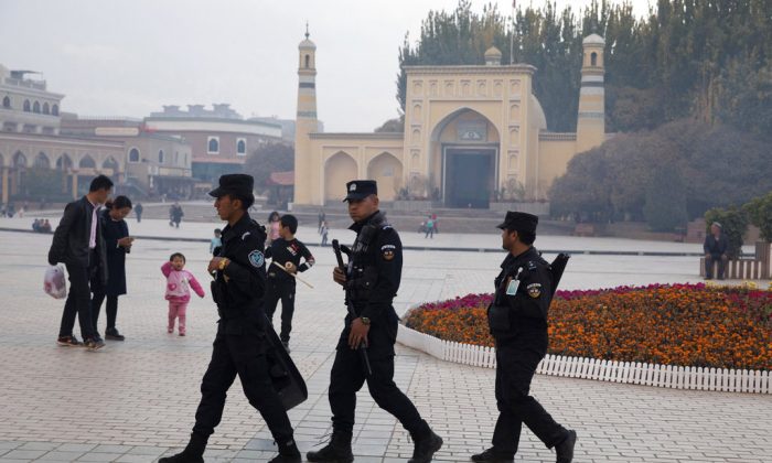 Uighur security personnel patrol near the Id Kah Mosque in Kashgar, Xinjiang region, China on Nov. 4, 2017. (Ng Han Guan/AP)