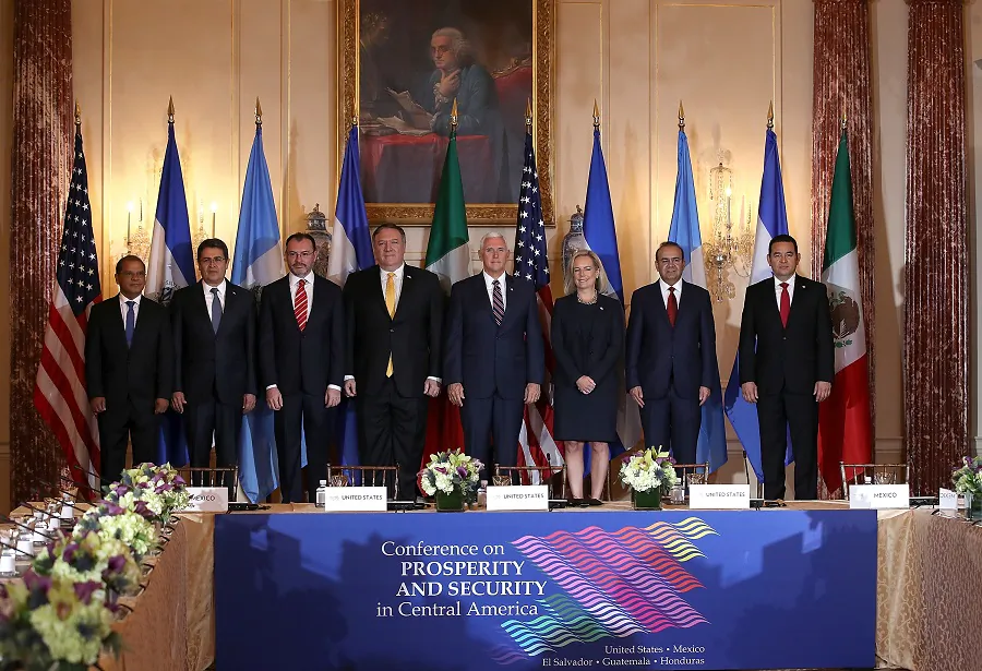 (L-R) El Salvador Vice President Oscar Ortiz, Honduras President Juan Orlando Hernandez, Mexican Foreign Secretary Luis Videgaray, U.S. Secretary of State Mike Pompeo, U.S. Vice President Mike Pence, Homeland Security Secretary Kirstjen Nielsen, Mexico Secretary of Government Alfonso Navarrete, and President of Guatemala Jimmy Morales pose for a photo at the start of the Conference for Prosperity and Security in Central America in Washington on Oct. 11, 2018. (Justin Sullivan/Getty Images)