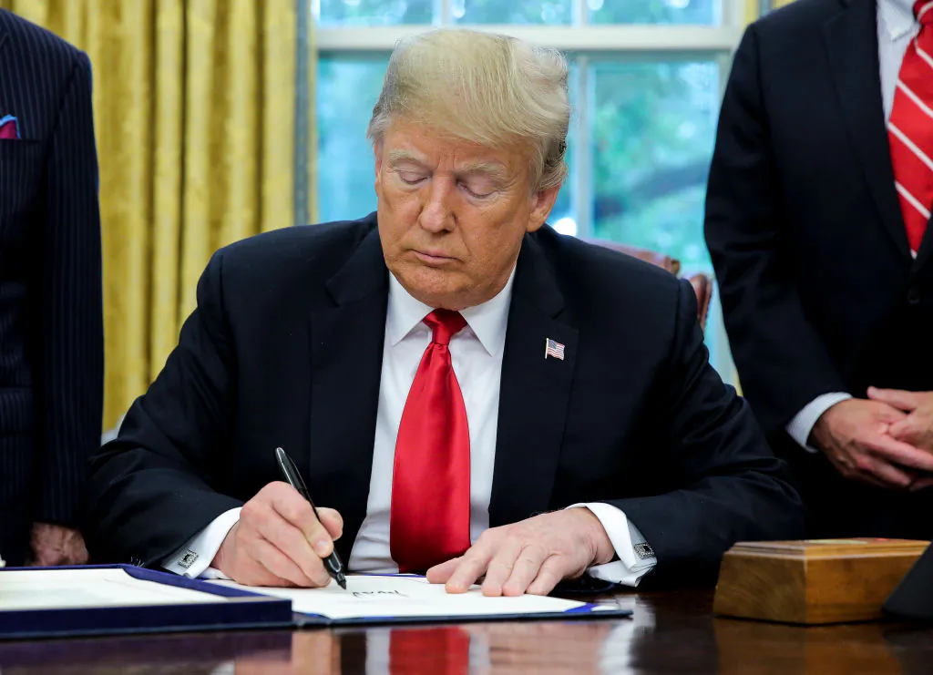 President Donald Trump signs S. 3508, the Save Our Seas Act of 2018, during a ceremony in the Oval Office of the White House on Oct. 11, 2018. (Oliver Contreras -Pool/Getty Images)