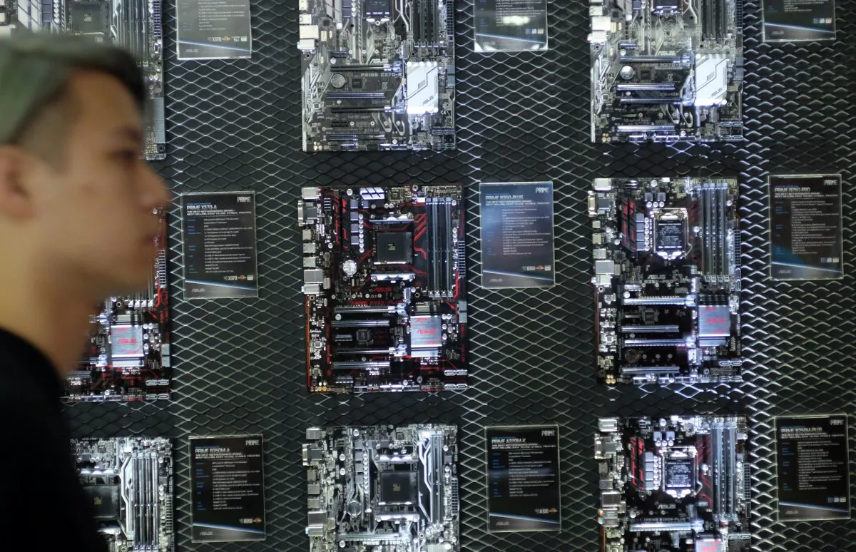 A visitor walks past a motherboard wall during the Computex Show in Taipei, on May 30, 2017. (SAM YEH/AFP/Getty Images)
