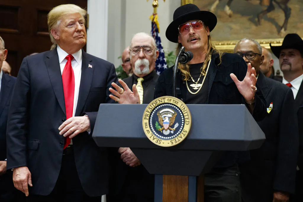 President Donald Trump looks on as musician Kid Rock speaks during a signing ceremony for the "Orrin G. Hatch-Bob Goodlatte Music Modernization Act," in the Roosevelt Room of the White House, on Oct. 11, 2018. (Evan Vucci/AP)