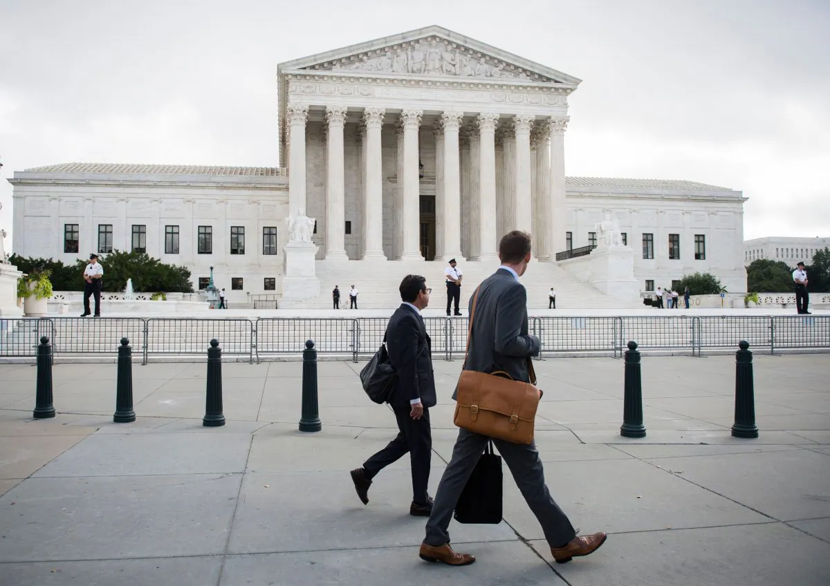 Two men walk in front of the Supreme Court on the first day that Justice Brett Kavanaugh will hear oral arguments in Washington, DC on October 9, 2018. The recent confirmation hearing of Justice Kavanaugh was messy perhaps because the procedures and processes for such hearings are not clear. (Andrew Caballero-Reynolds/AFP/Getty Images)