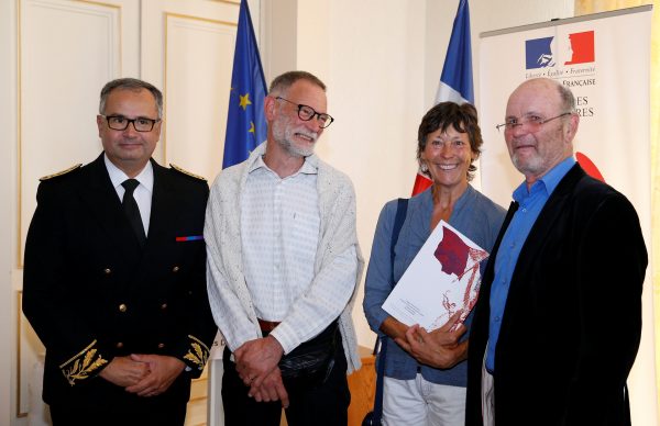 Amanda Holmes and her husband Robin hold a French naturalization decree