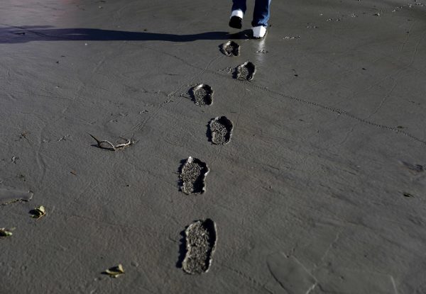 David Blackston walks through muddy parking