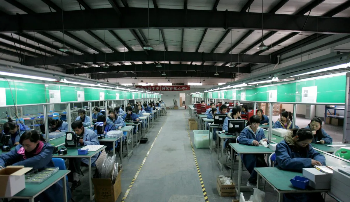 Workers on an assembly line at a factory in Chengdu City, Sichuan Province, China, on February 19, 2009. (China Photos/Getty Images)