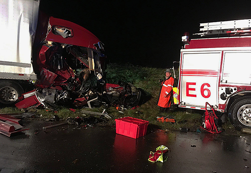 A tractor-trailer crashed into the back of a fire truck