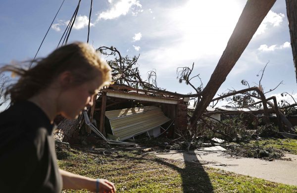 Kelsey Gronbeck walks damaged homes