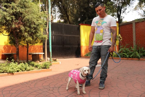 Animal care attendant Jair Rodriguez with rescued dog Hannah.