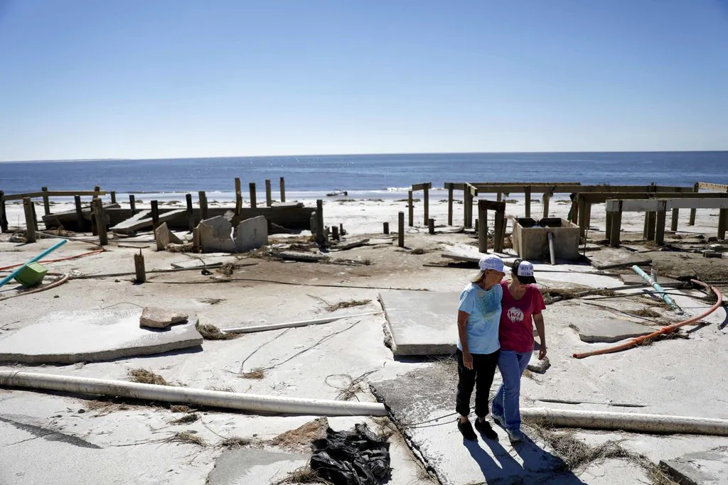 Joy Hutchinson, left, is comforted by her daughter Jessica Hutchinson, as she returns to find her home swept away from hurricane Michael in MEXICO BEACH, Fla on Oct. 12, 2018. (AP Photo/David Goldman, File)