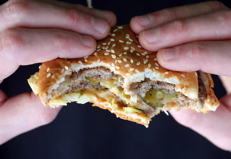 A man holds a burger purchased from a fast-food outlet on Jan. 7, 2013, in Bristol, England. (Matt Cardy/Getty Images)