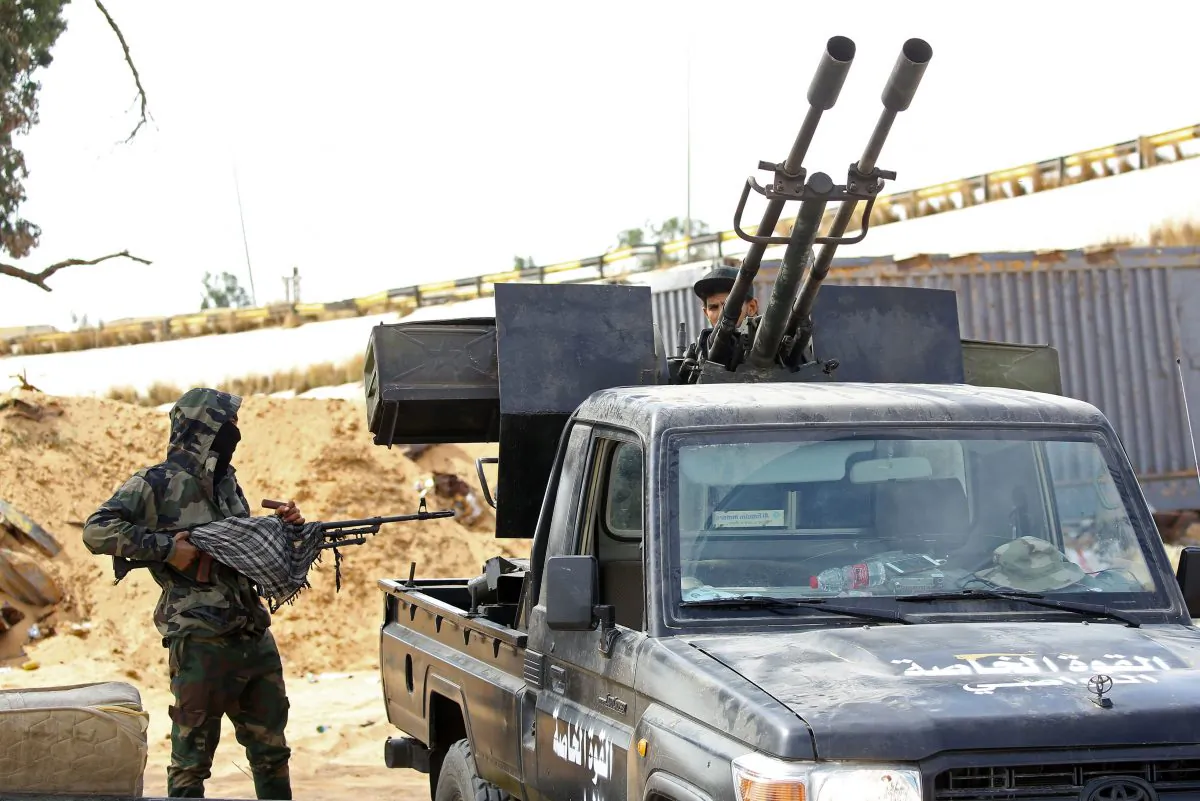 Libyan militiamen loyal to the Government of National Accord (GNA), Libya's internationally recognised government, keep watch from a position south of the Libyan capital Tripoli on Sept. 25, 2018. (MAHMUD TURKIA/AFP/Getty Images)