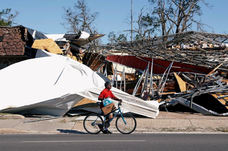 Man carrying food and water on bike
