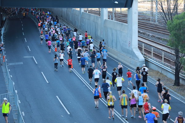 Marathon runners moving down the road