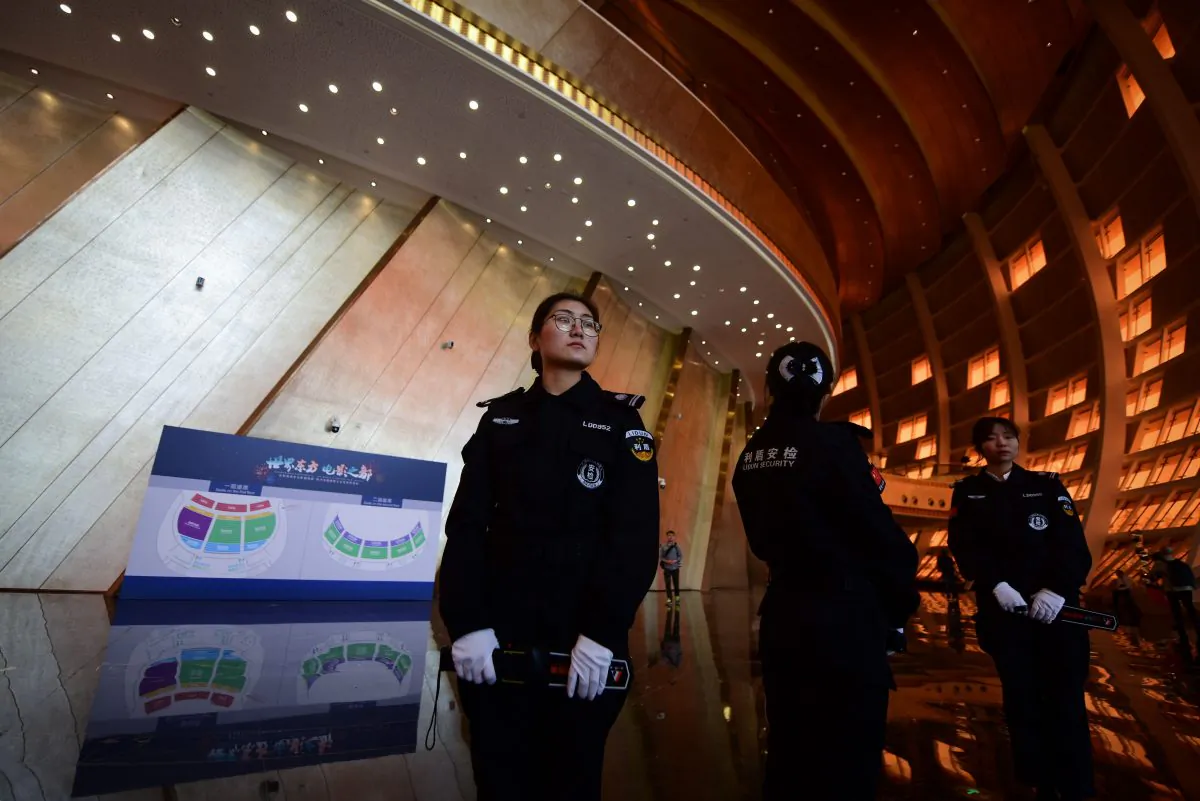 Security guards stand at the entrance of the Wanda Qingdao Movie Metropolis before its opening ceremony in Qingdao, China's Shandong province on April 28, 2018. (WANG ZHAO/AFP/Getty Images)