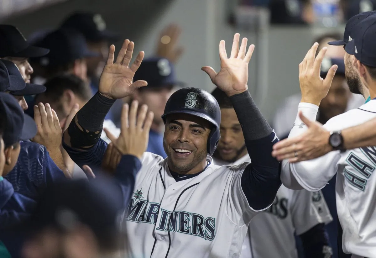 Nelson Cruz #23 of the Seattle Mariners is congratulated by teammates after scoring on a hit by Mitch Haniger #17 of the Seattle Mariners off of relief pitcher Will Harris #36 of the Houston Astros during the sixth inning of a game at Safeco Field in Seattle, Wash. on Sept. 6, 2017. (Stephen Brashear/Getty Images)