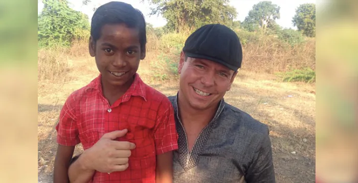 Jerry Hughes with a boy he met through the Wheels of Hope program in India. (Courtesy of Jerry Hughes)