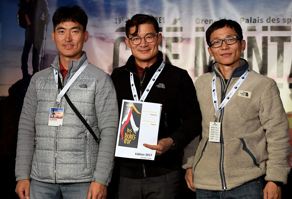 South-Korean mountaineer Kim Chang-ho (C), who died during a snowstorm in the Himalayas on Oct. 11, poses for pictures with other mountaineers ahead of an awarding ceremony in Grenoble, France, on Nov. 8, 2017. (Jean-Pierre Clatot/AFP/Getty Images)