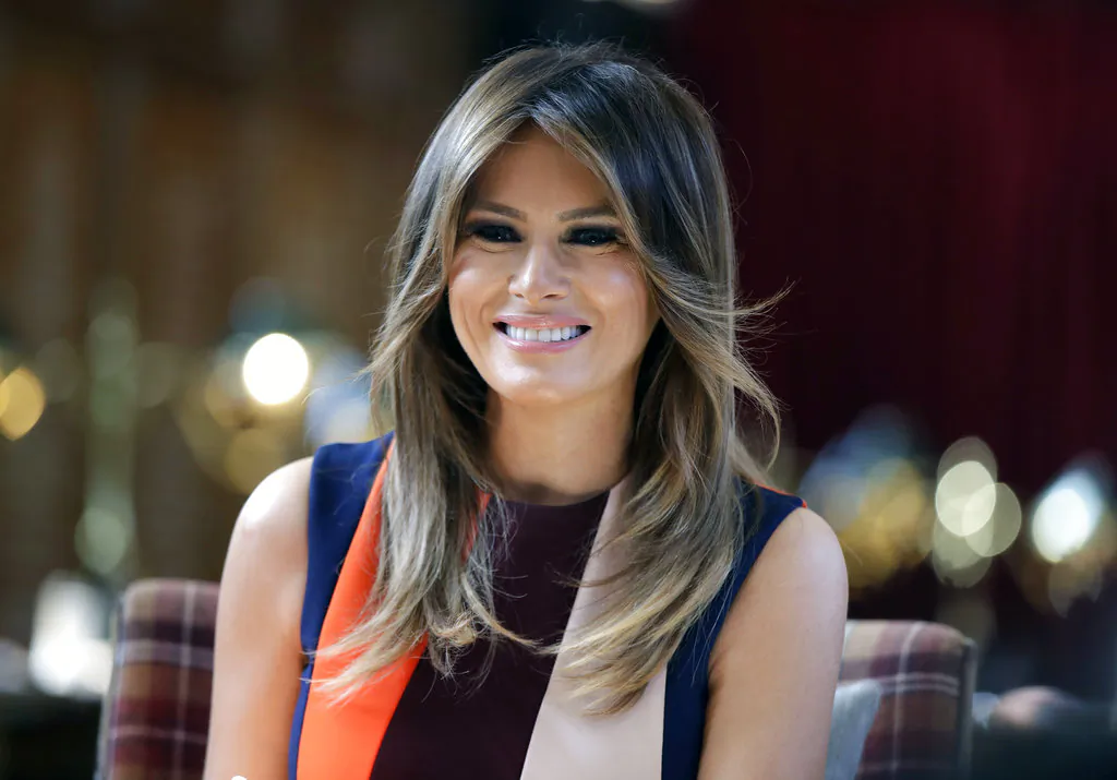 First Lady Melania Trump takes a seat during a visit to The Royal Hospital Chelsea in central London on Jul. 13, 2018. (Luca Bruno/AP Photo, Pool)