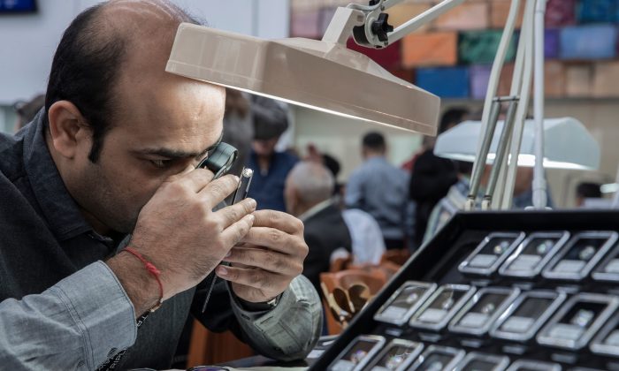 A foreign buyer checks the quality of a diamond in the Israeli town of Ramat Gan, east of Tel Aviv, on Feb. 5, 2018. (Jack Guez/AFP/Getty Images)