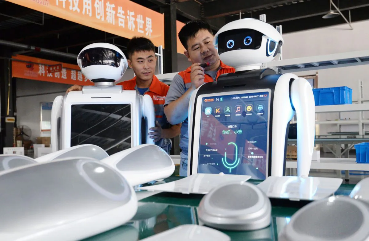 Employees assemble robots at a factory in Handan, Hebei Province, China on Aug. 27, 2018. (STR/AFP/Getty Images)