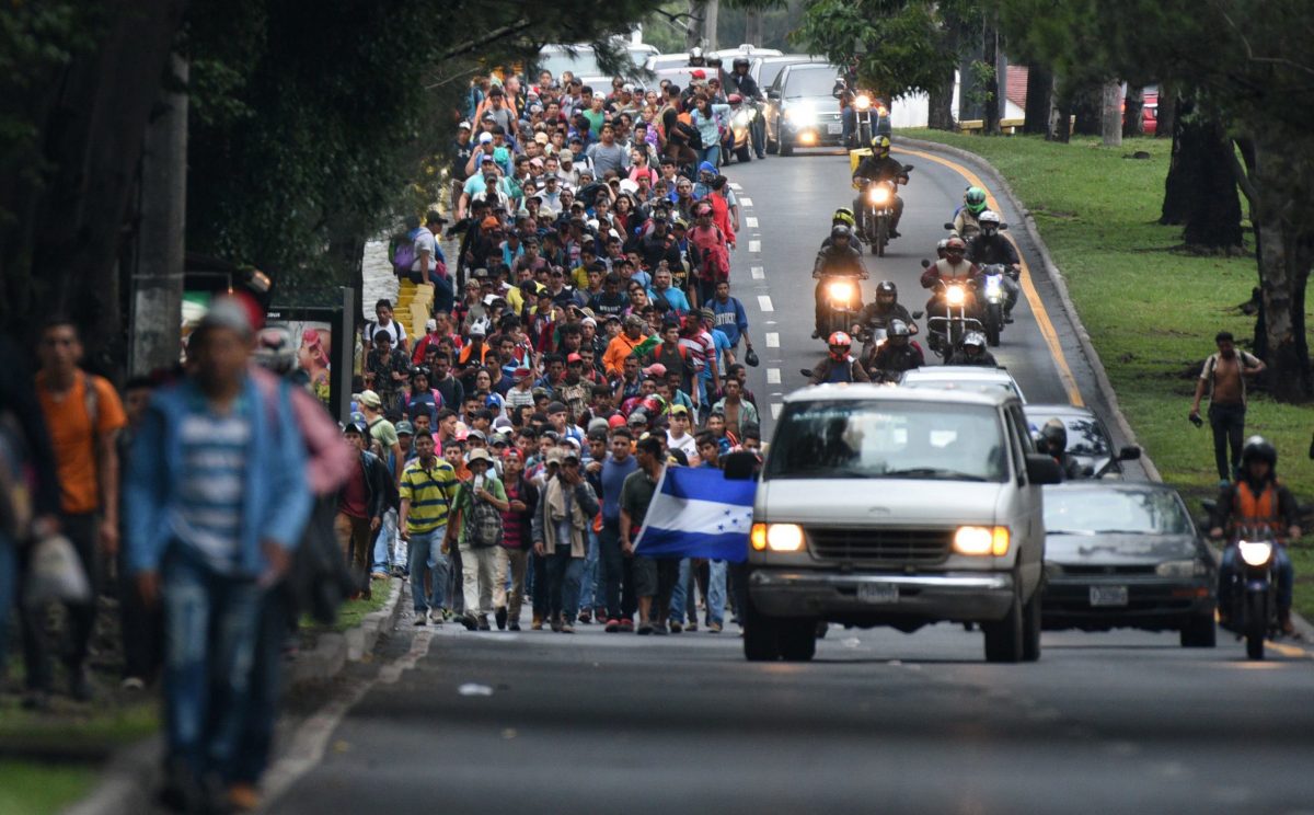Honduran migrants heading in a caravan to the United States, walk in direction to the border with Mexico as they leave Guatemala City