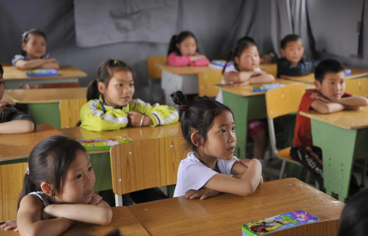 Children listen to their teacher in a classroom in the town of Mianyang, Sichuan Province, China, on May 22, 2008. (PETER PARKS/AFP/Getty Images)