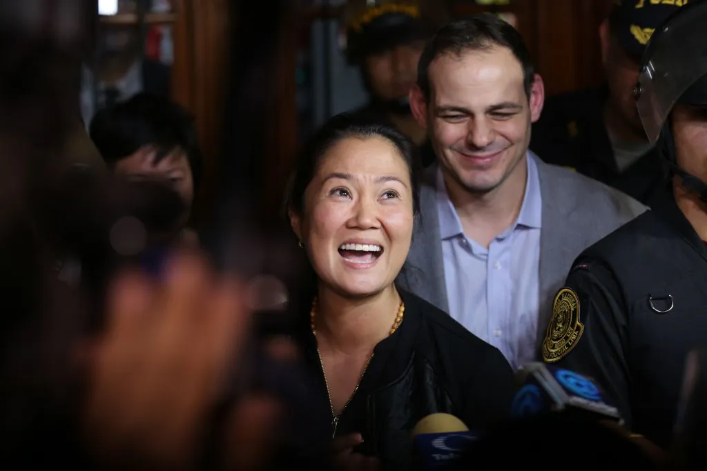 Keiko Fujimori, the leader of Peruvian opposition party Fuerza Popular, gestures, flanked by her husband Mark Vito, as she leaves the national criminal court in Lima on Oct. 17, 2018. (Luka Gonzales/AFP/Getty Images)
