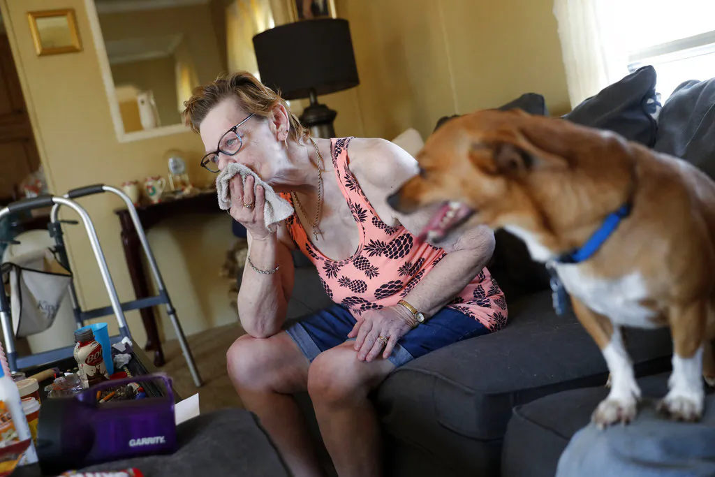 Sandra Sheffield, 72, uses a washcloth to wipe sweat from her face, in her home, which now has no electricity, in the aftermath of Hurricane Michael in Panama City, Fla. on Oct. 17, 2018. (AP Photo/Gerald Herbert)