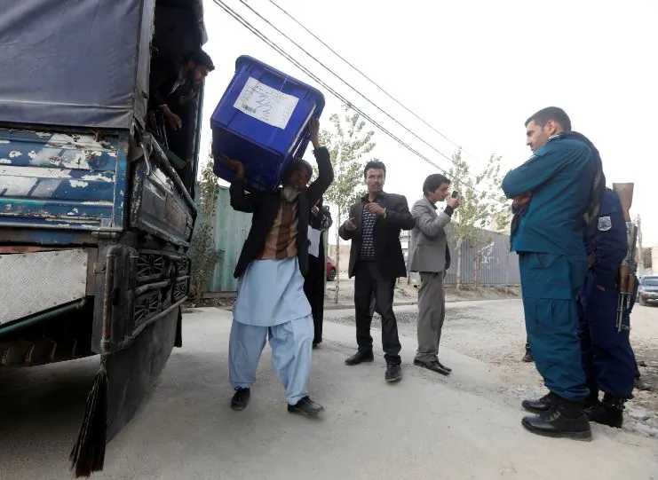 Afghan election commission unloads a ballot box with election material outside a polling station in Kabul, Afghanistan Oct. 19, 2018. (Reuters/Omar Sobhani)