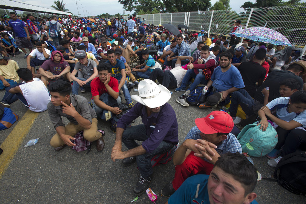 migrant caravan on bridge