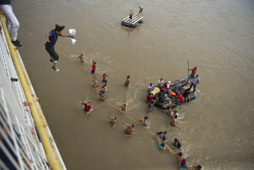 migrants jump off bridge