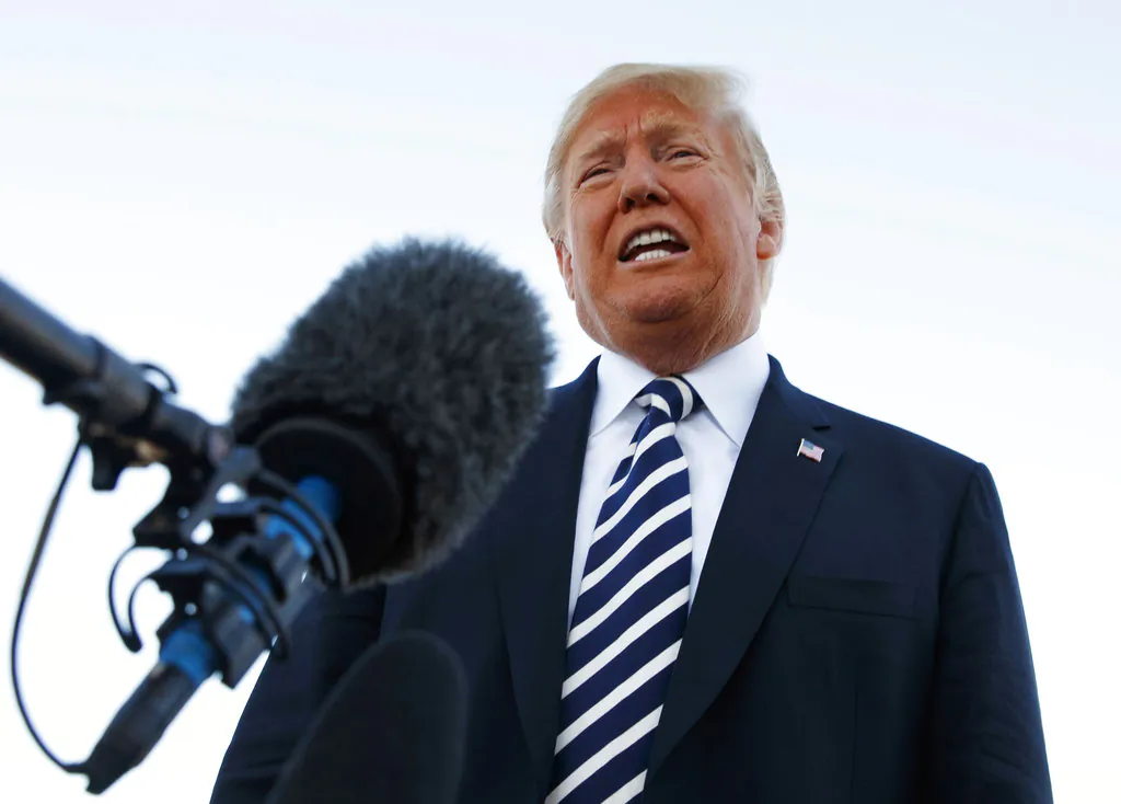 President Donald Trump speaks to media before boarding Air Force One at Elko Regional Airport, on Oct. 20, 2018, in Elko, Nev., after a campaign rally. (AP Photo/Carolyn Kaster)