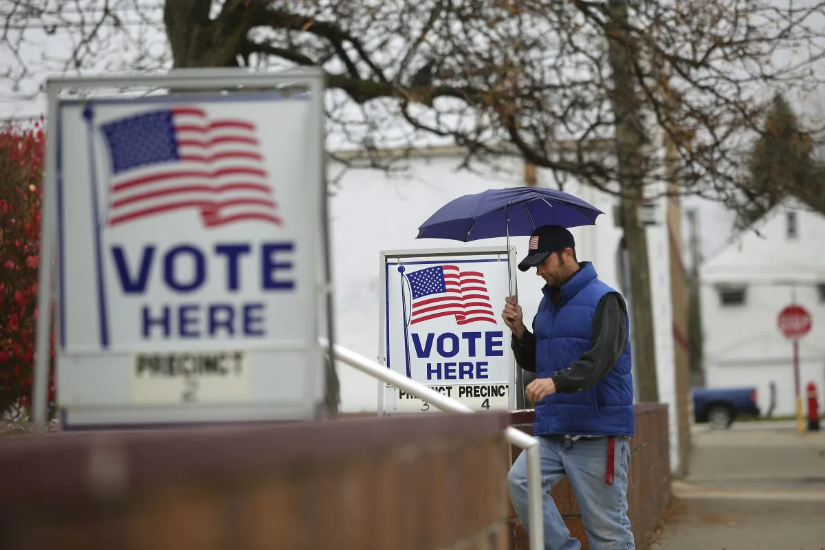 A man fills walks past voting signs displayed outside a polling station during the mid-term elections in Hamtramck, Michigan, in this  Nov. 4, 2014 file photo. (Joshua Lott/Getty Images)