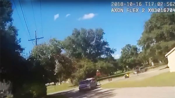 The suspect tries to pull a woman out of her minivan
