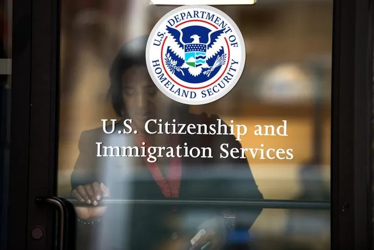A woman leaves the U.S. Citizenship and Immigration Services offices in New York on Aug. 15, 2012. (Reuters/Keith Bedford)