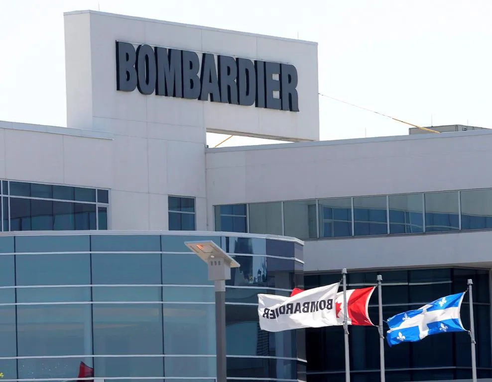 Flags fly outside a Bombardier plant in Montreal in this file photo. (The Canadian Press/Ryan Remiorz)