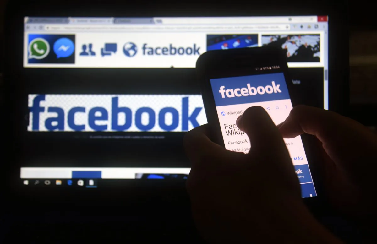 A cellphone and a computer screen display the logo of the social networking site Facebook. (Norberto Duarte/AFP/Getty Images)